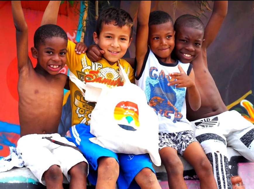 Children holding Language Land bag